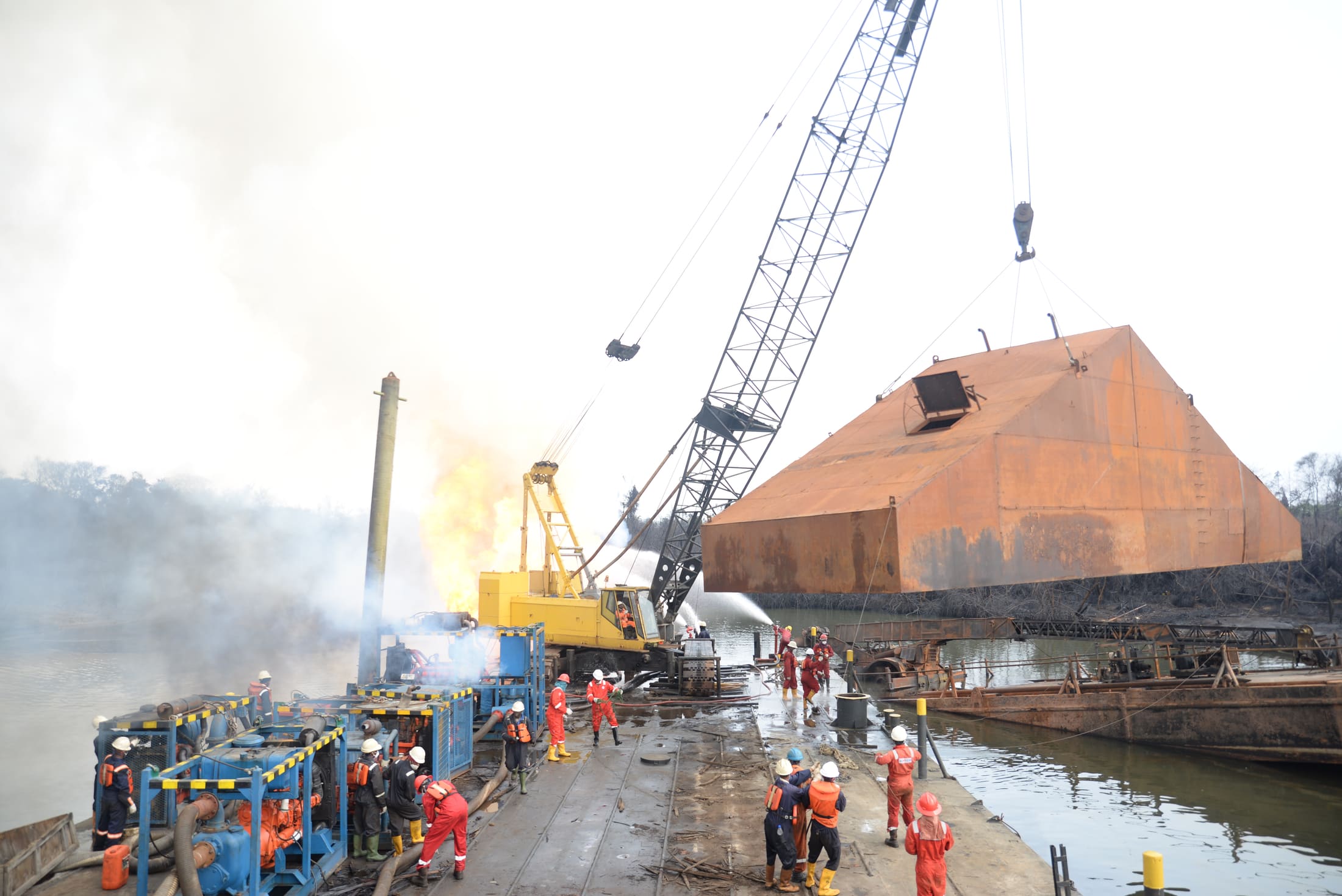 Emergency response crew and crane controlling a wellsite flare