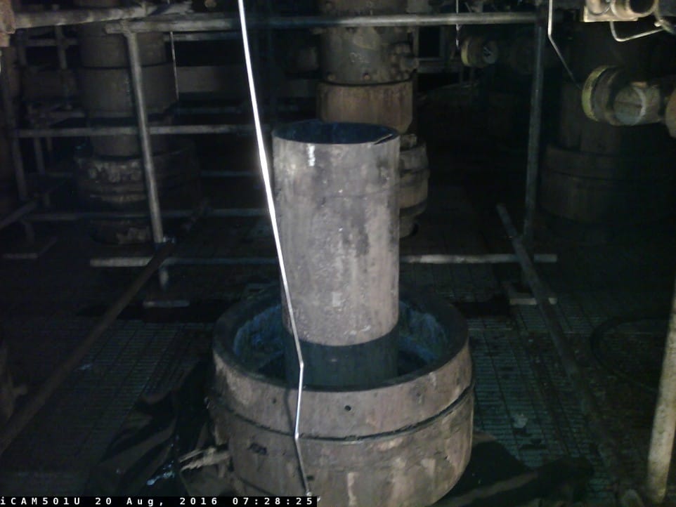 A section of casing cleanly severed by a cold cutting tool in an excavated cellar