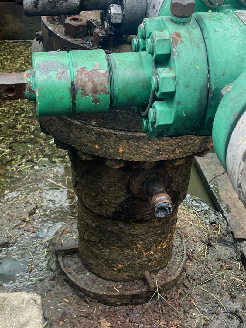 A gate valve being fitted onto a corroded wellhead riser