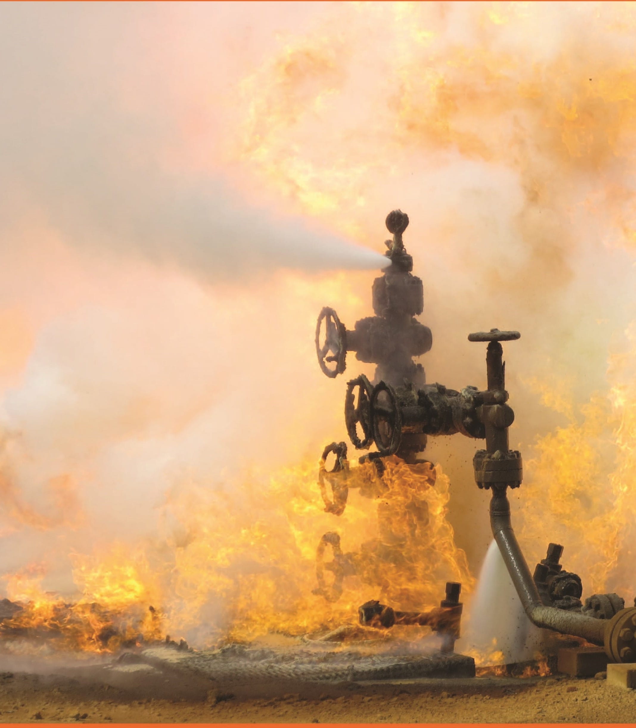 A wellhead engulfed in flame with crew directing a water stream onto the fire