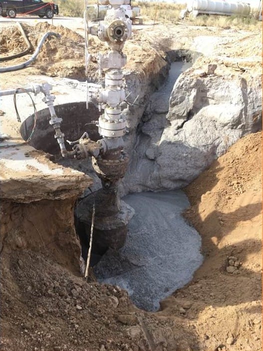 A wellhead assembly being stabilized in an excavated cellar during recovery